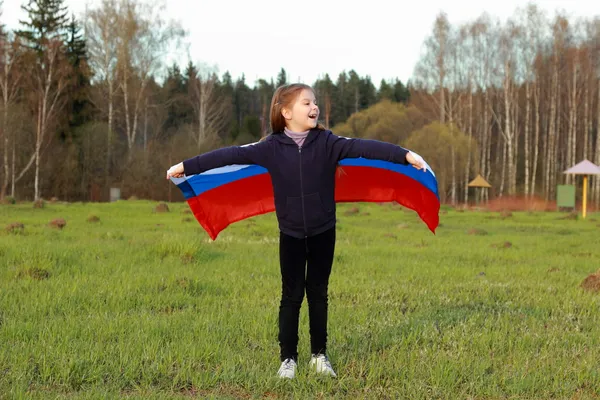 Girl holding a large Russian flag — Stock Photo, Image