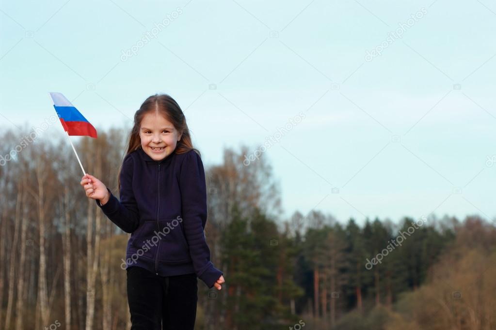 Patriotic little girl holding Russian flag