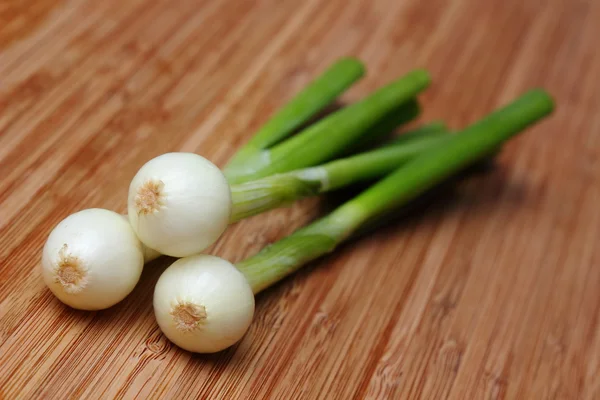 Young onion bulbs with green sprouts — Stock Photo, Image