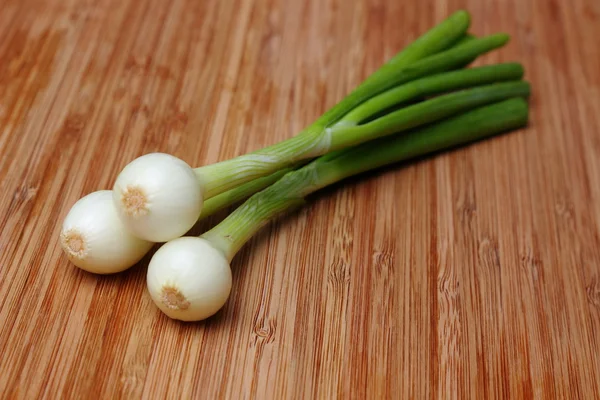 Young onion bulbs with green sprouts — Stock Photo, Image