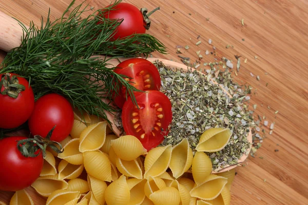 Uncooked pasta and fresh tomatoes — Stock Photo, Image