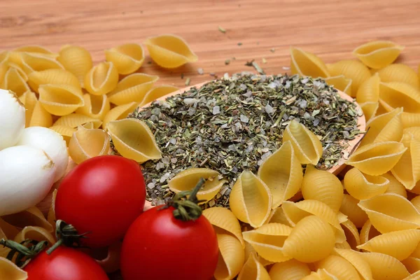 Uncooked pasta and fresh tomatoes