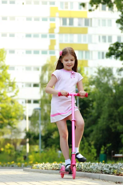 Little girl riding scooter — Stock Photo, Image