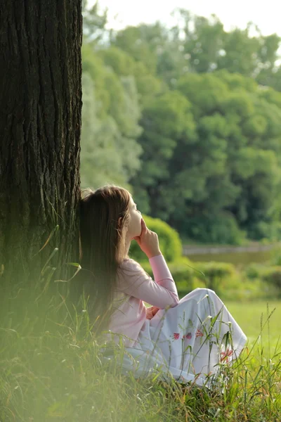 Little girl on green grass — Stock Photo, Image