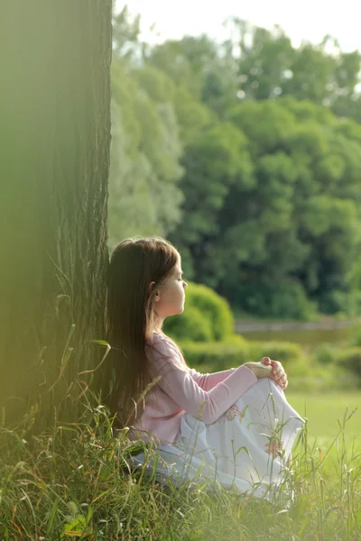 Little girl on green grass — Stock Photo, Image