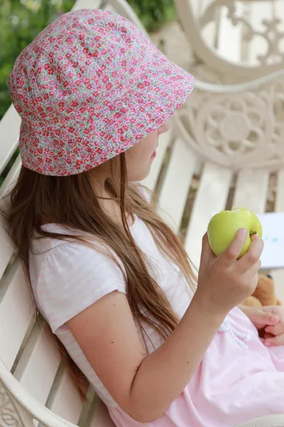 Beautiful little girl with green apple — Stock Photo, Image
