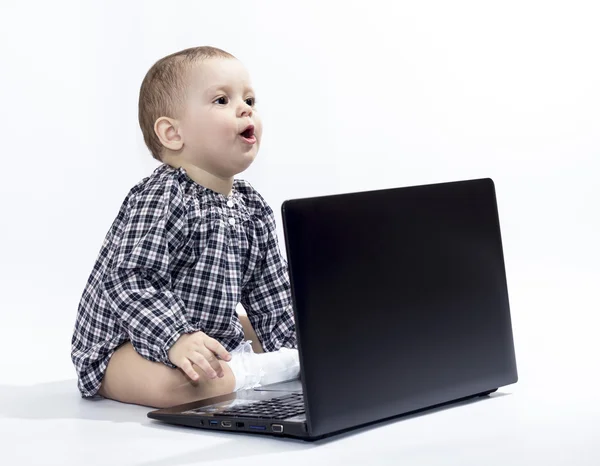 Little girl with a laptop — Stock Photo, Image