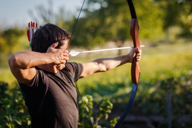 Young archer training with the bow clipart