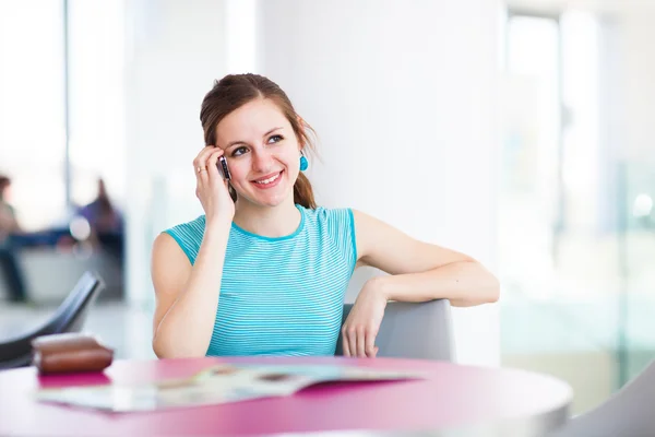 Mooie jonge vrouw met behulp van haar mobiele telefoon — Stockfoto