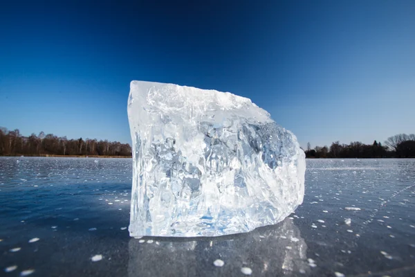 Freezing winter temperatures: block of ice lying on the surface — Stock Photo, Image