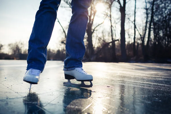 Young woman ice skating outdoors on a pond on a beautiful sunny day — Stock Photo, Image
