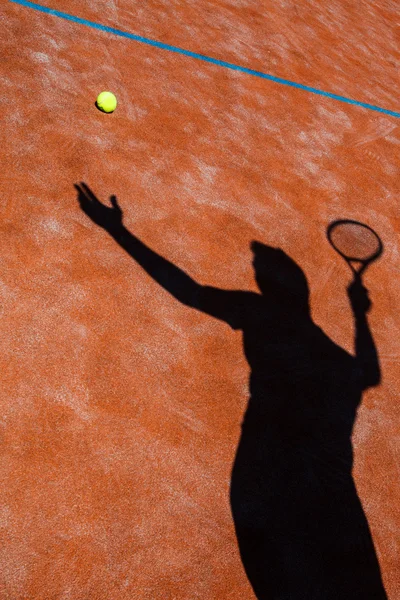 Тінь тенісиста в дії на тенісному корті (концепція туру — стокове фото