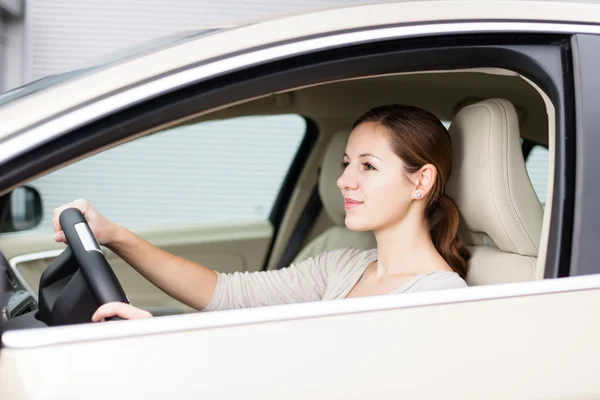 Pretty young woman driving her new car Royalty Free Stock Photos