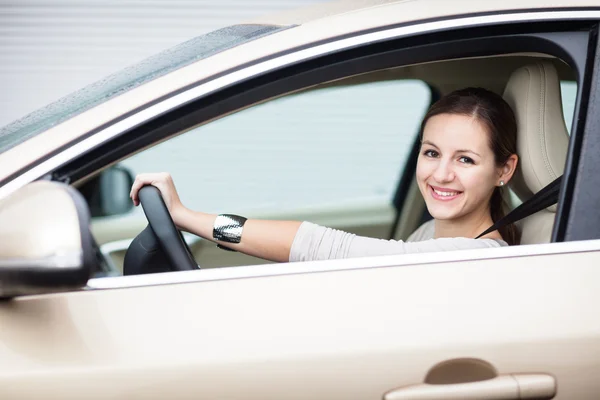 Pretty young woman driving her new car Stock Picture
