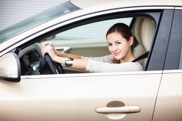 Pretty young woman driving her new car Stock Picture