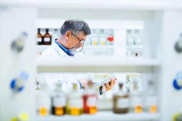 Senior scientist using his tablet computer at work — Stock Photo, Image