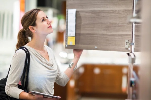 Young woman shopping for furniture in a furniture store — Stock Photo, Image