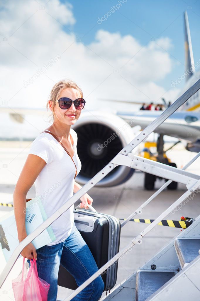 Departure - young woman at an airport about to board an aircraft