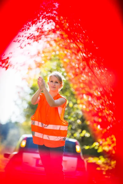 Young female driver wearing a high visibility vest — Stock Photo, Image