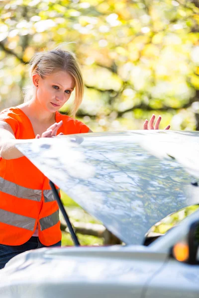 Young female driver wearing a high visibility vest — Stock Photo, Image