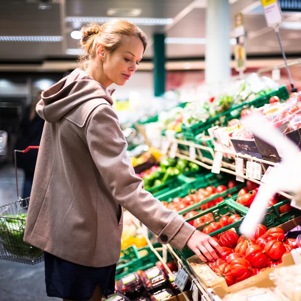 Jolie jeune femme qui achète des fruits et légumes — Photo