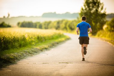 Male athlete,runner running on road clipart