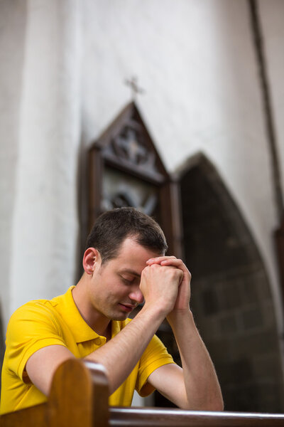 Man praying in a church