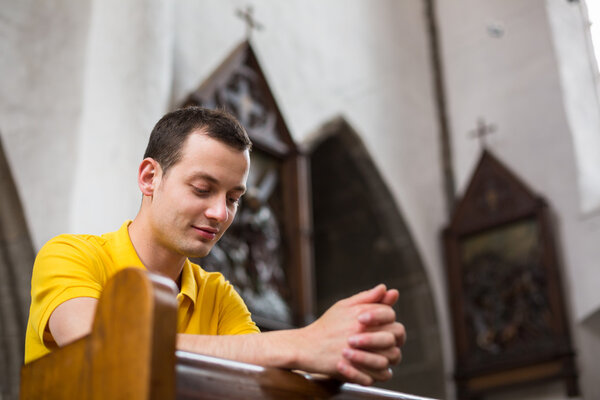 Man praying in a church