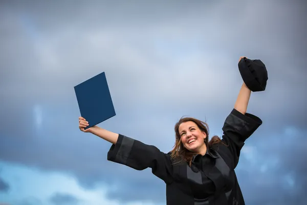 Jovem celebrando alegremente sua formatura — Fotografia de Stock