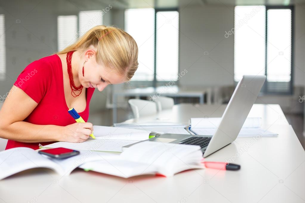 Female student with books and laptop