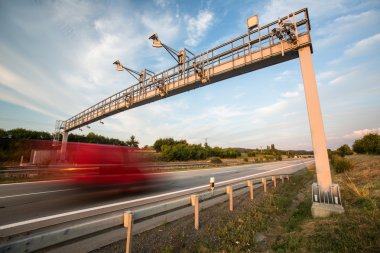 Truck passing through a toll gate clipart