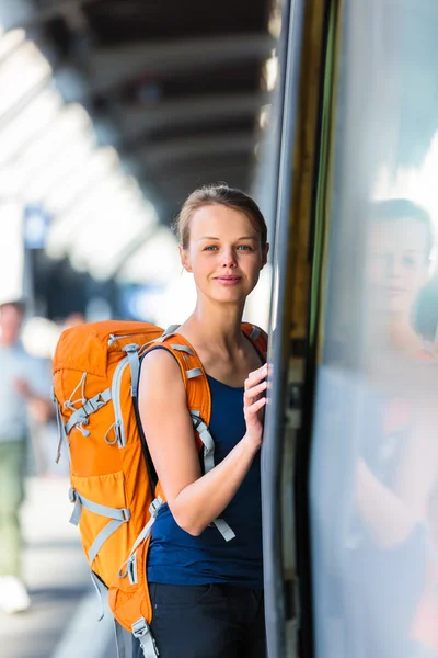 Mulher em uma estação de trem, embarcando em um trem — Fotografia de Stock