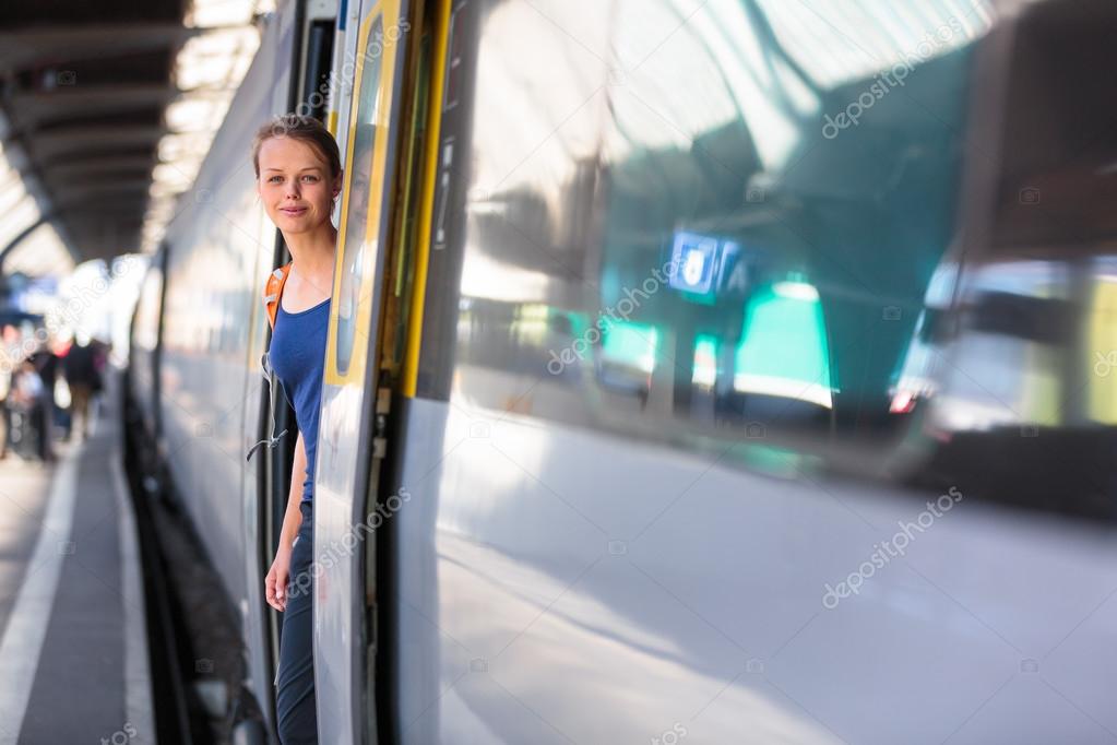 Woman in a trainstation, boarding a train