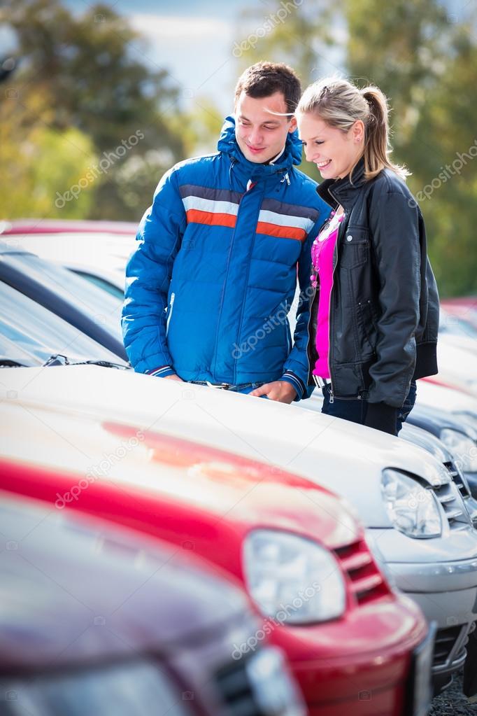 Young couple choosing car