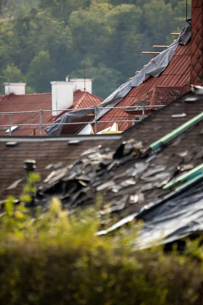 Storm damaged roof, destroyed roof tiles, expensive damage needing prompt repair