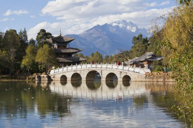 Lijiang old town and Jade Dragon Snow Mountain in China clipart