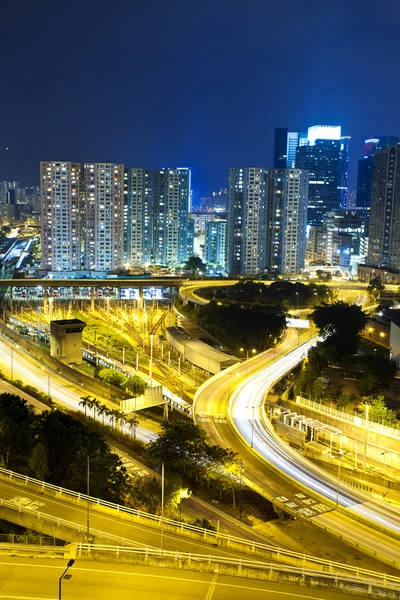 Office buildings and highway in city at night — Stock Photo, Image