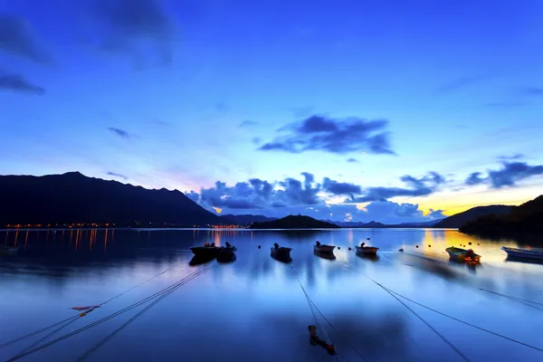 Sunrise coast with fishing boats — Stock Photo, Image