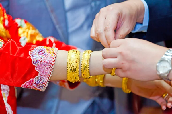 Elderly relatives presenting the golden bracelet as a blessing i — Stock Photo, Image