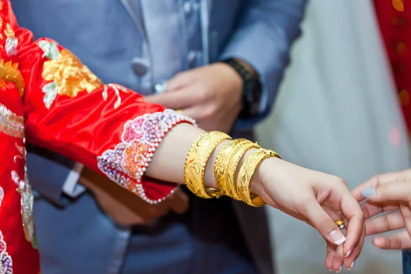 Elderly relatives presenting the golden bracelet as a blessing i — Stock Photo, Image