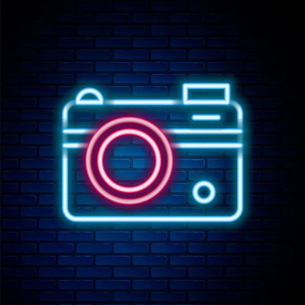 Glowing neon line Photo camera icon isolated on brick wall background. Foto camera. Digital photography. Colorful outline concept. Vector — Stock Vector