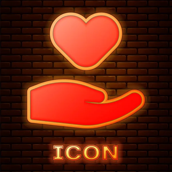 Gloeiende neon Hart in de hand pictogram geïsoleerd op baksteen muur achtergrond. Hand geven liefdessymbool. Valentijnsdag symbool. Vector — Stockvector