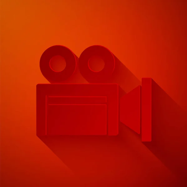 Папір вирізав піктограму камери кінотеатру ізольовано на червоному тлі. Відеокамера. Знак фільму. Плівковий проектор. Стиль паперового мистецтва. Векторні — стоковий вектор