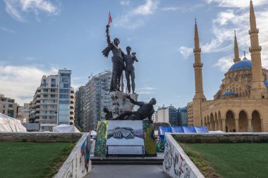 Beirut, Lebanon - March 5, 2020: Monument on a Square of Martyrs in Beirut, Blue Mosque on background clipart
