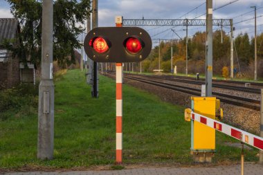 Red lights on a railroad cross in Rogow village, Lodzkie Province of Poland clipart
