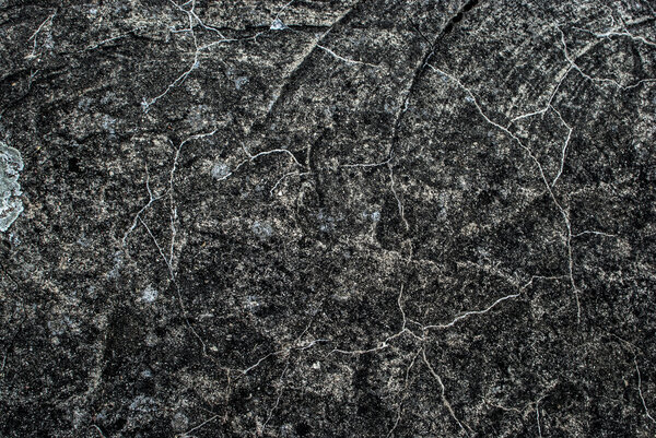 background from a gray rough surface of stone