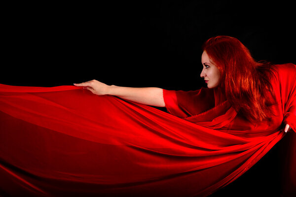 Effective beautiful girl with fabric and red hair