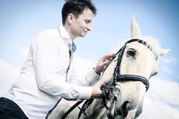 Unusual groom at wedding on white horse outdoors — Stock Photo, Image