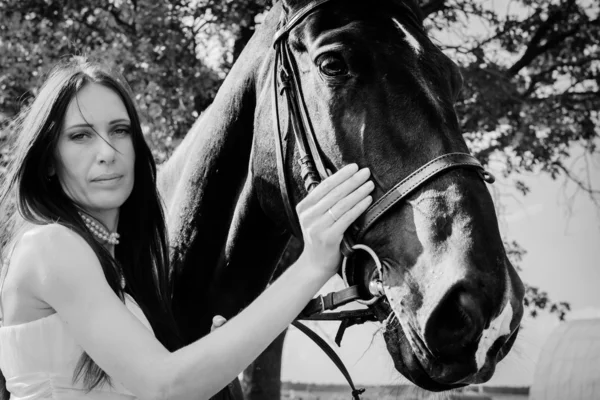 Unusual bride at wedding on black horse outdoors — Stock Photo, Image