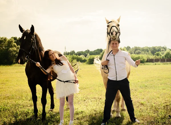 Wedding of unusual couple happy near horses — Stock Photo, Image